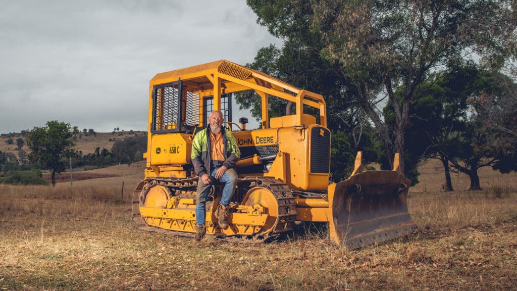 Todd Reiser from Blackbutt Logging with their refurbished John Deere 450C Dozer his father purchased in the 80s.